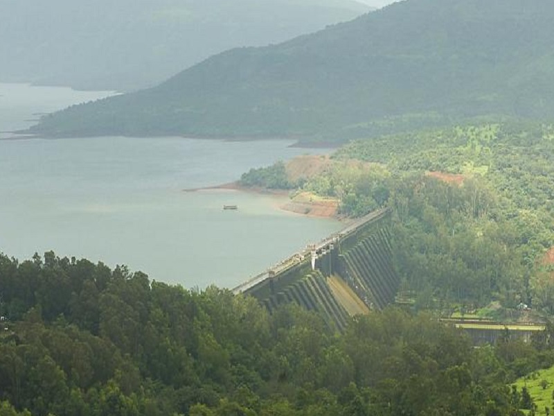 “Riverside camping in Satara with bonfire and tents”